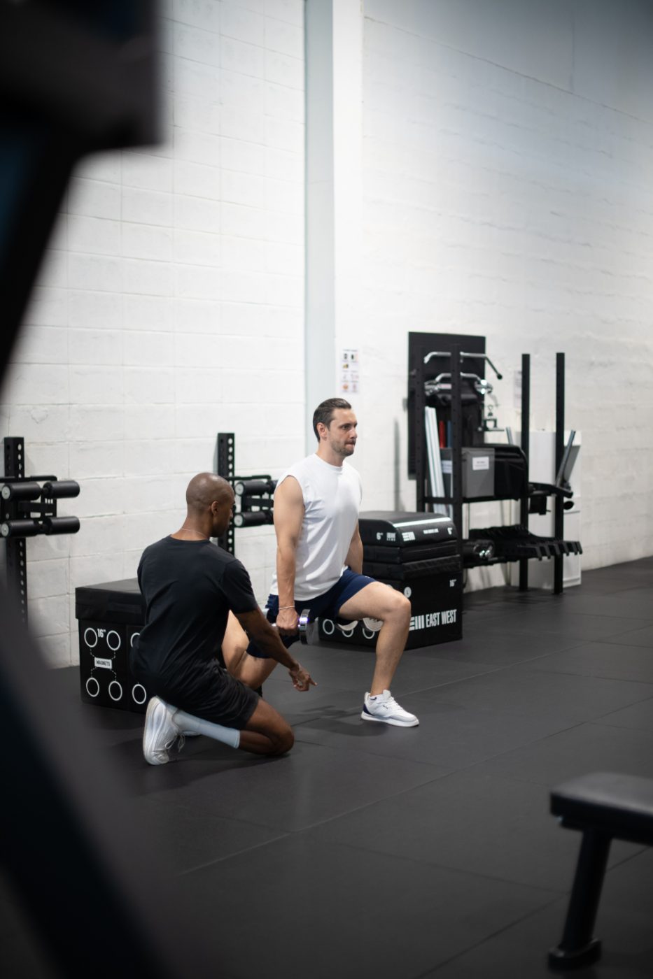 Jonathan Colorado coaching a professional client through a split squat in a private New York studio