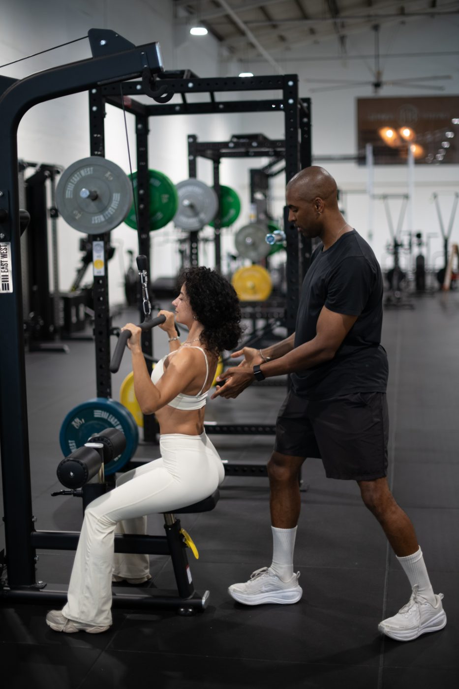 Jonathan Colorado coaching a client on a lat pulldown to preserve muscle while training on GLP-1 medications