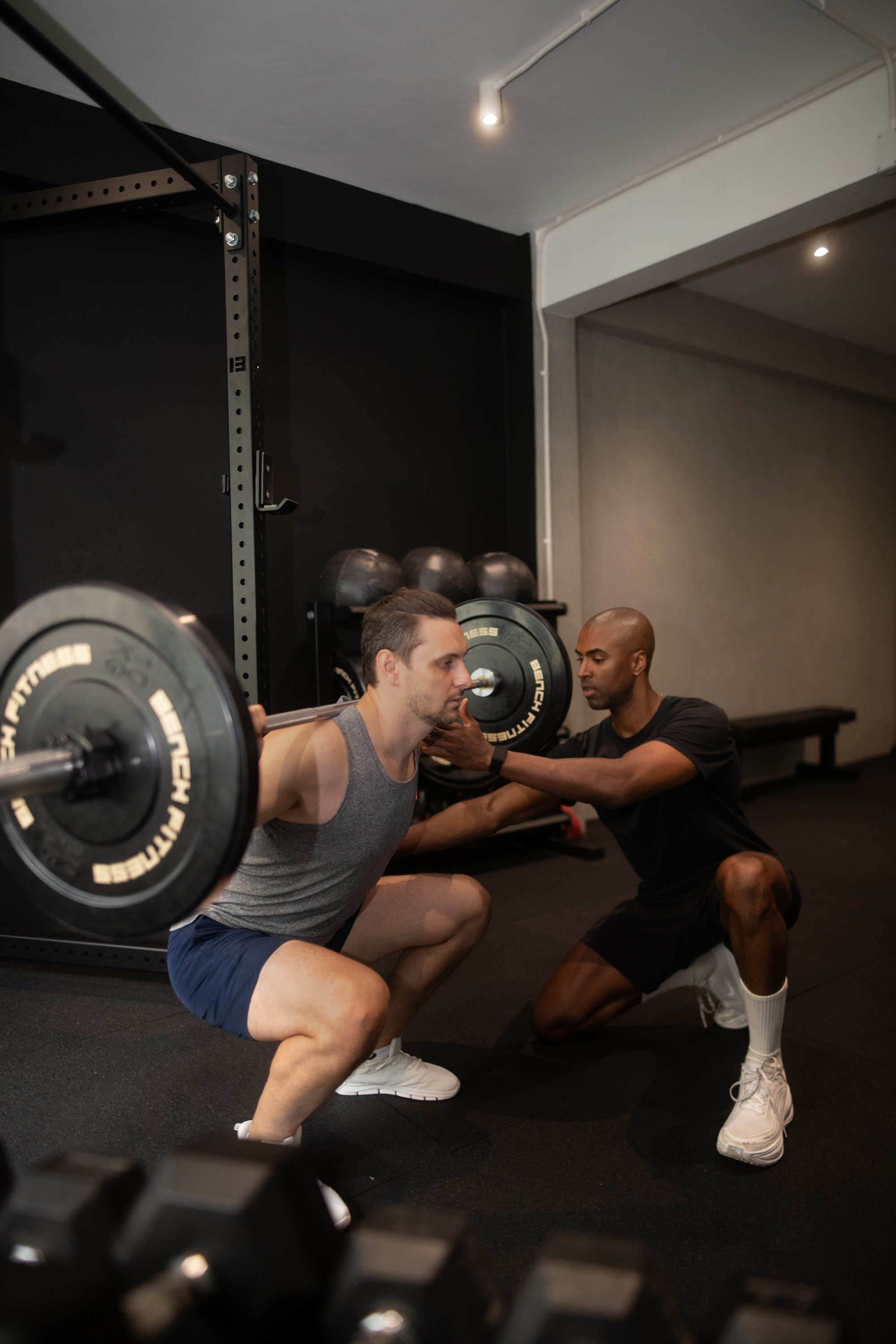 Jonathan coaching a client on a lat pulldown